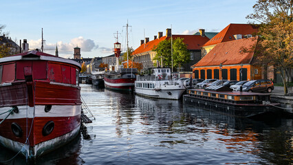Scene from Copenhagen Denmark with both boats and water in a canal