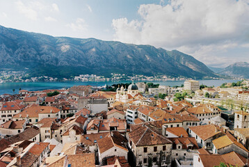 Fototapeta na wymiar Red tiled roofs of ancient houses in the port of Kotor. Montenegro