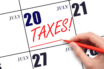 Hand drawing red line and writing the text Taxes on calendar date July 20. Remind date of tax...