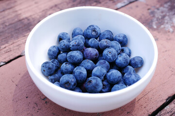 Close up of fresh blue berry with water drops .