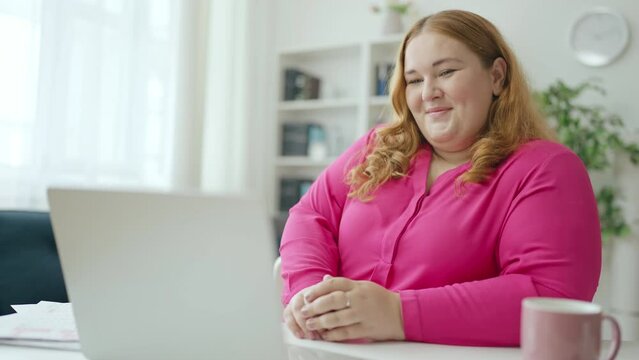Excited curvy woman making online order on laptop and smiling, modern technology