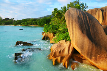 Anse Source d'Argent beach with big granite rocks at sunset. La Digue Island, Indian Ocean, Seychelles. Tropical destination.