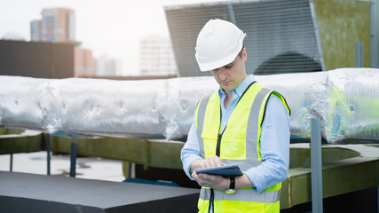 Engineer is checking the cooling system for the air conditioning in a large building or industrial...