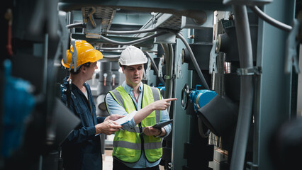 Engineer and team examining the air conditioning cooling system of a huge building or industrial...