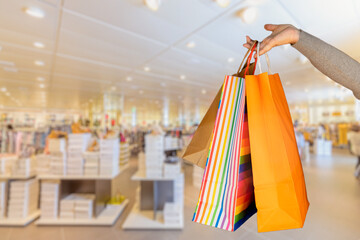 Shopping bags in the woman hands. Joy of consumption. Purchases, black friday, discounts, sale concept..