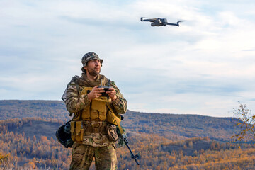 Photo of an artillery spotter or military observer launches a drone into the sky for reconnaissance...