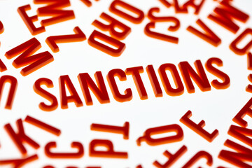 
Sanctions. Letters on a light background. News headline.
