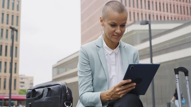 Beautiful modern business woman with shaved head at work during a business journey