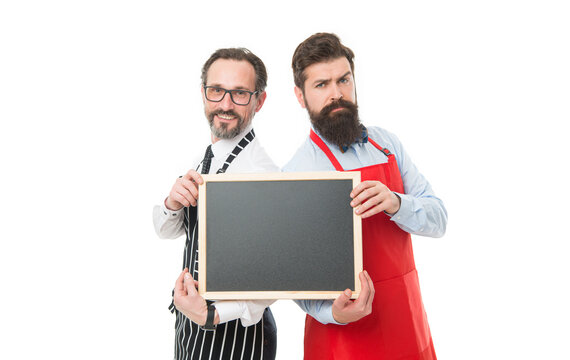 Men bearded bartender in apron hold blank chalkboard. Bartender with blackboard advertisement. Hipster bartender show blackboard copy space. Join us. Hiring restaurant staff. Men bearded informing
