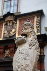 Fototapeta na wymiar Stone statue of a crowned lion at Schweizertor, Vienna, Austria