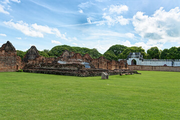 Fototapeta na wymiar The ruin of King Narai palace at Lopburi Province, Thailand, which green field is in the foreground. King Narai ruled Ayutthaya Kingdom from 1656 to 1688.