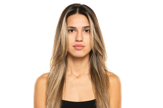 beautiful young women with long balayage painted hair and no makeup on a white background.