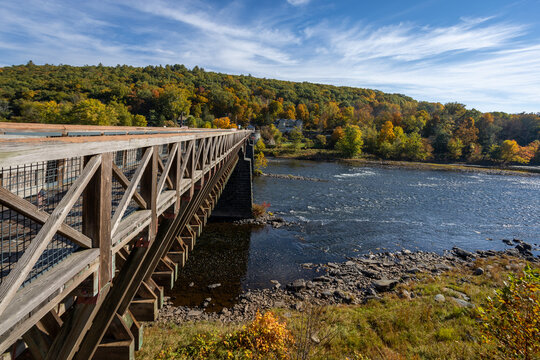 Historic Roebling Bridge also known as Roebling's Delaware Aqueduct over the Delaware River on a brilliant fall morning - Powered by Adobe