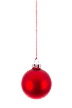 Red Christmas ball hanging at a rope over white