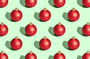 Pattern of christmas balls on green pastel background