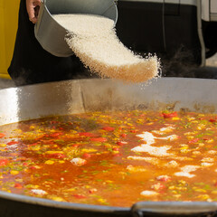 AÑADIENDO ARROZ A LA PAELLA GIGANTE