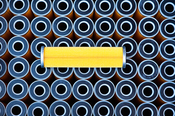 New yellow machine filters, stacked to each other and one filter on top of them.