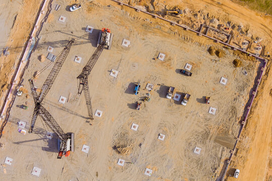 Construction of vertical piling foundation on with truck mounted pump drilling soil under columns putting concrete, sweat earth into piles