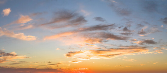 Naklejka na ściany i meble Blue sky with golden clouds sunset background