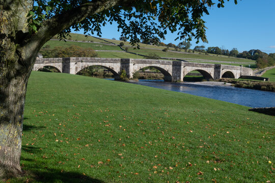 Burnsall Bridge Framed By A Tree. 