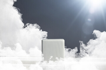 A pedestal in the form of a white cube on a gray background with sun rays and smoke. Pedestal for product presentation. Basis for work