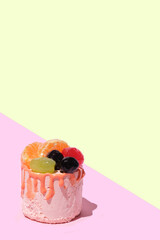 Top view of sweet cake berries and fruits, fruits tart biscuit on a pink background. Copy space, minimalism.