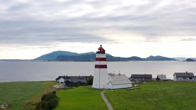 Flying above the iconic Alnes Lighthouse on a cloudy day, Aerial Orbit