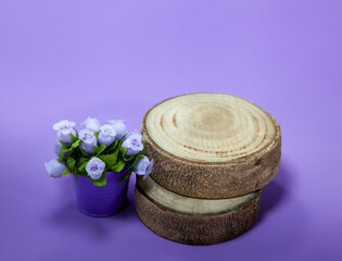 Product display podium with round wood with flowers. Lilac colors with top view.