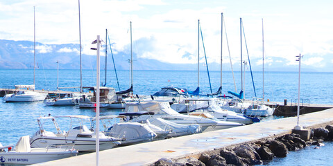 Corfu, Greece - October 12, 2021: Yachts and boats parking in harbor. Beautiful Yachts in blue sky and sea background. Travel, adventure, vacation concept. Yachting.
