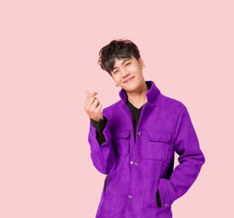 Portrait of a happy Asian handsome man in fashionable purple jacket clothing standing smiling using...