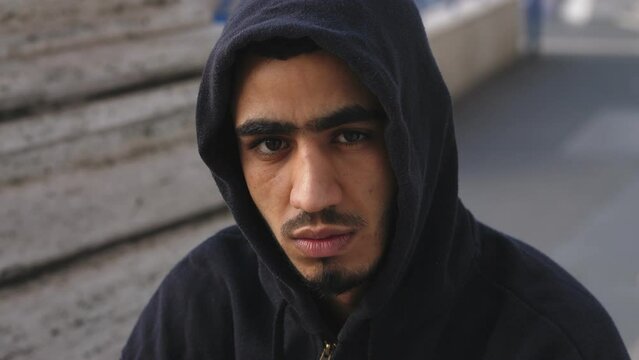 Close up on Serious young immigrant tunisian staring at camera