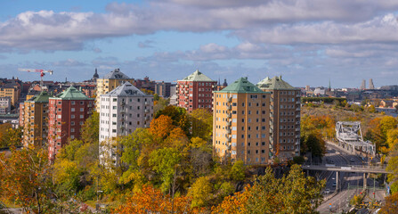 Fototapeta na wymiar Skyscrapers on a hill at the Danviken passage to the Hammarby Strand a sunny a color full autumn day in Stockholm