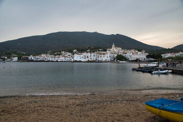 Fototapeta na wymiar Seascape the village of Cadaqués, near Barcelona. Picturesque old town with a beautiful beach. Isolated fishing village in the mountains. Famous tourist destination on the Costa Brava with the landmar