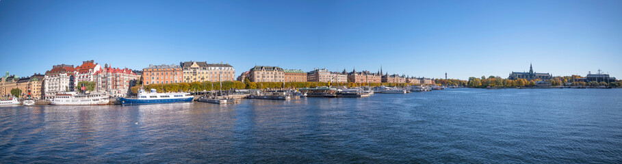Fototapeta na wymiar Hotel and office houses at the street Strandvägen in the bay Nybroviken a sunny a color full autumn day in Stockholm