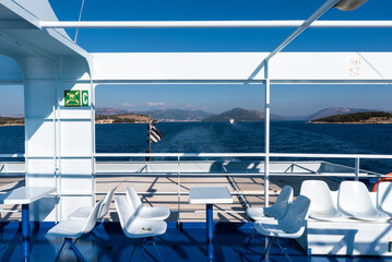 Fototapeta premium Ferry boat deck with empty seats and sea view. Mediterranean sea, Greece.