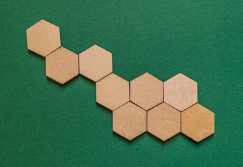 several hexagonal wooden plates on a green background