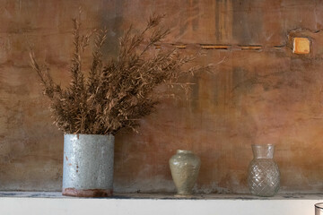 Dried flowers in a grey Vase on Burnt Orange Wall