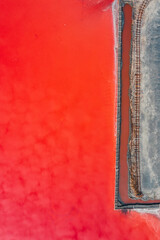Birdseye view of a saltworks red color lake Abstract Drone Shot