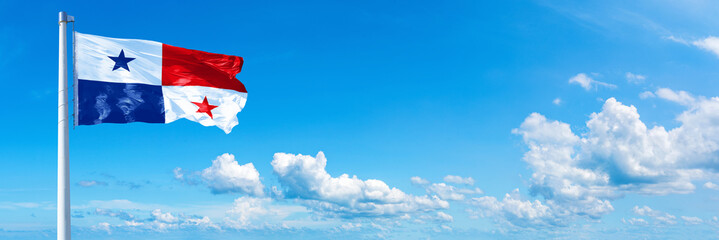 Panama flag waving on a blue sky in beautiful clouds - Horizontal banner