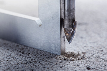Ceramic drill bit make holes in concrete wall with industrial drill. Building work industry.