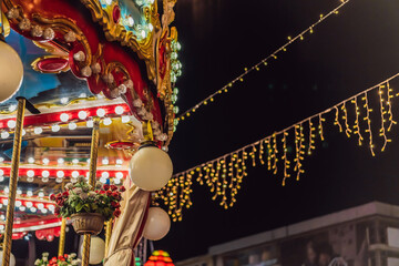 Illuminated swing chain carousel in amusement park at night