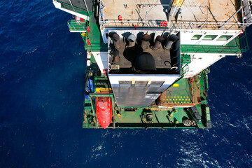 Aft construction part of container cargo vessel with funnel tubes, free fall lifeboat and mooring...