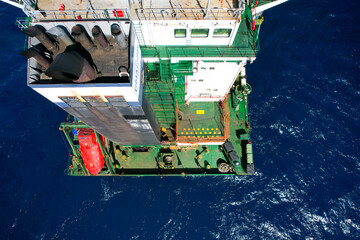 Aft construction part of container cargo vessel with funnel tubes, free fall lifeboat and mooring...