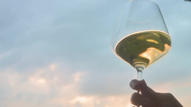 Woman testing and shaking white wine in the glass. 4k video footage UHD 3840x2160