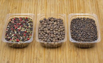 A mixture of peppers, allspice and black pepper closeup