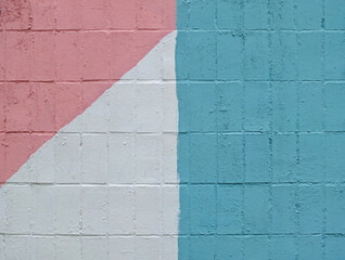 Colorful painted tile wall (white, blue, pink) as background or texture