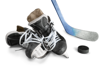 Pair of hockey skates with Hockey stick and puck isolated on white background