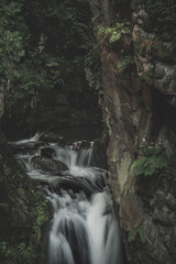 Naklejka na ściany i meble Mountain waterfall during fall