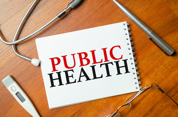 word public health with stethoscope on wooden background