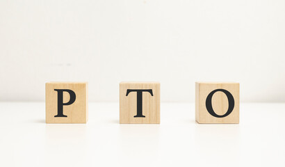 word pto with wood building blocks and white background